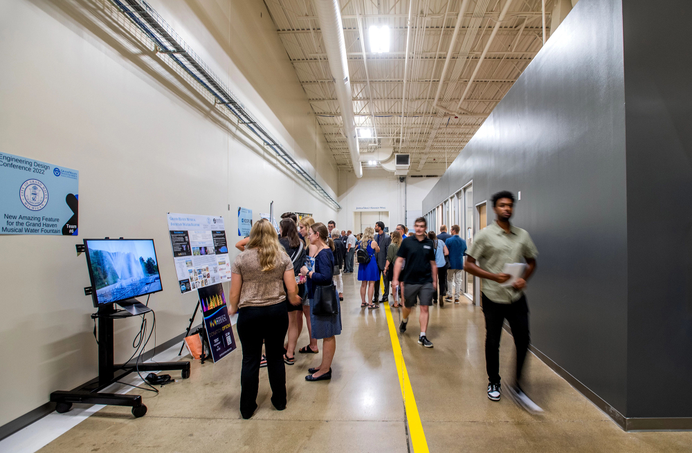 crowded hallway full of students giving presentations at the Innovation Design Center
