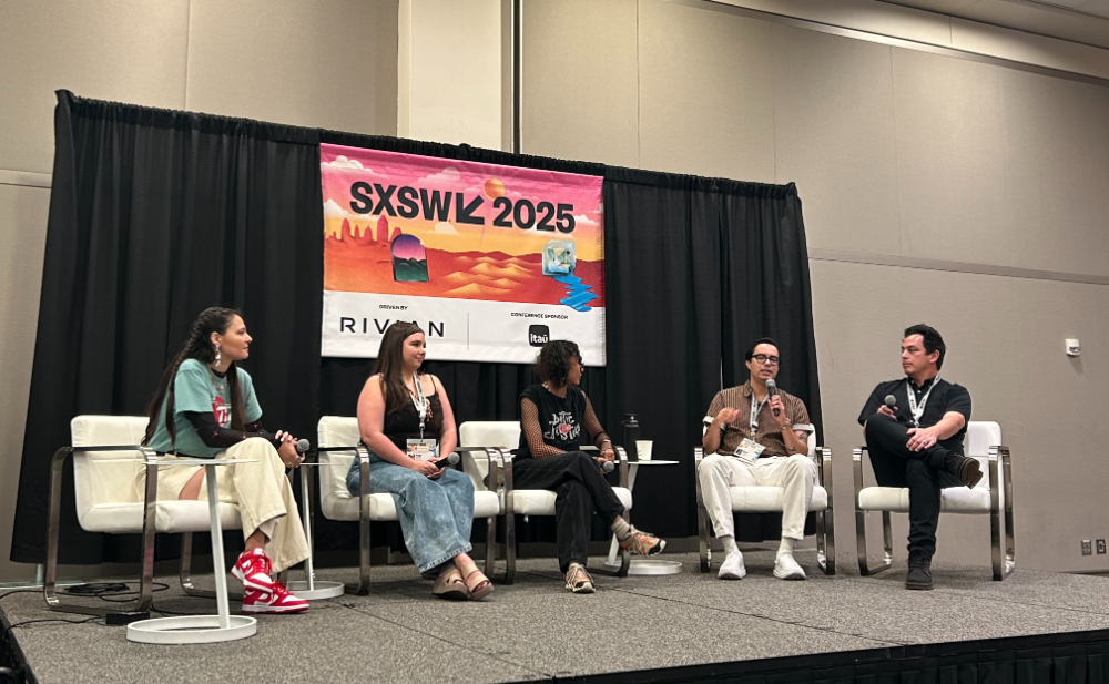 five people seated in chairs, man second from right with microphone at SXSW 2025