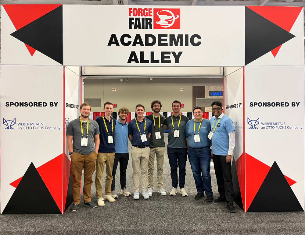 group standing in row under signage, Forge Fair Academic Alley