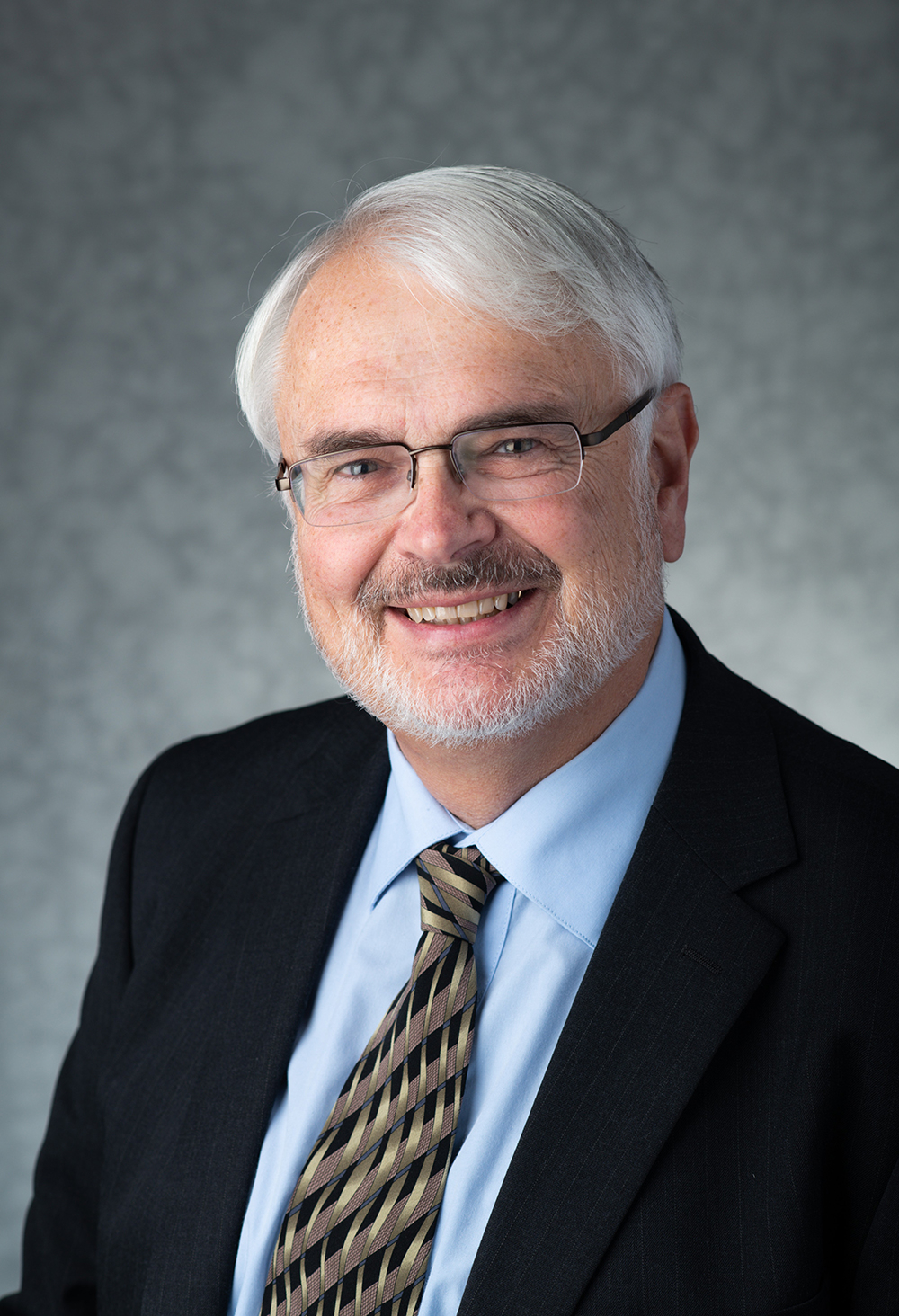 portrait of Rick Rediske against a gray background