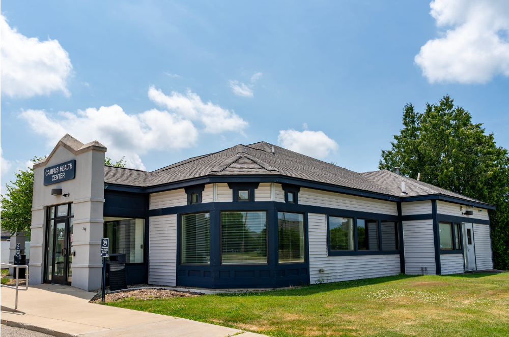 exterior of Campus Health Center, blue sky, trees in background
