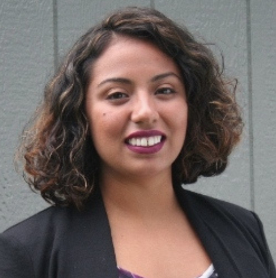 headshot of Delia Fernandez-Jones in a dark jacket