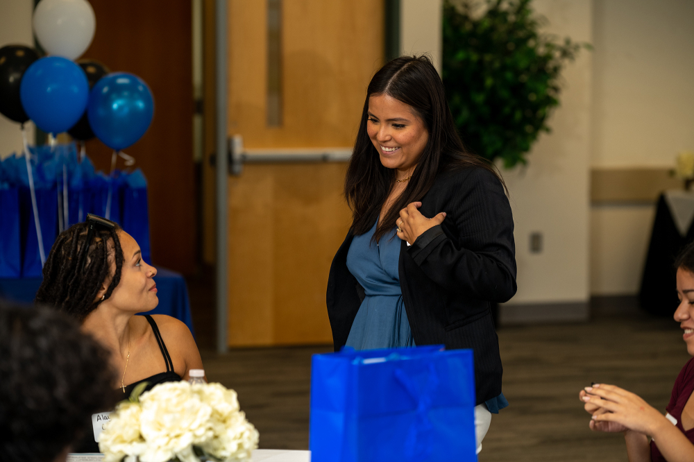Estefany Paniagua-Pardo, career navigator for the Battle Creek Regional Outreach Center, speaks to students seated at a table