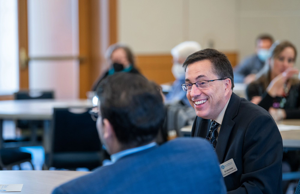 two people at a table, others at tables in background