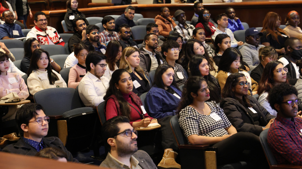 students seated in Loosemore Auditorium listening to presentations