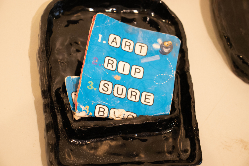 art object with book on top, cover reads Art, Rip, Sure