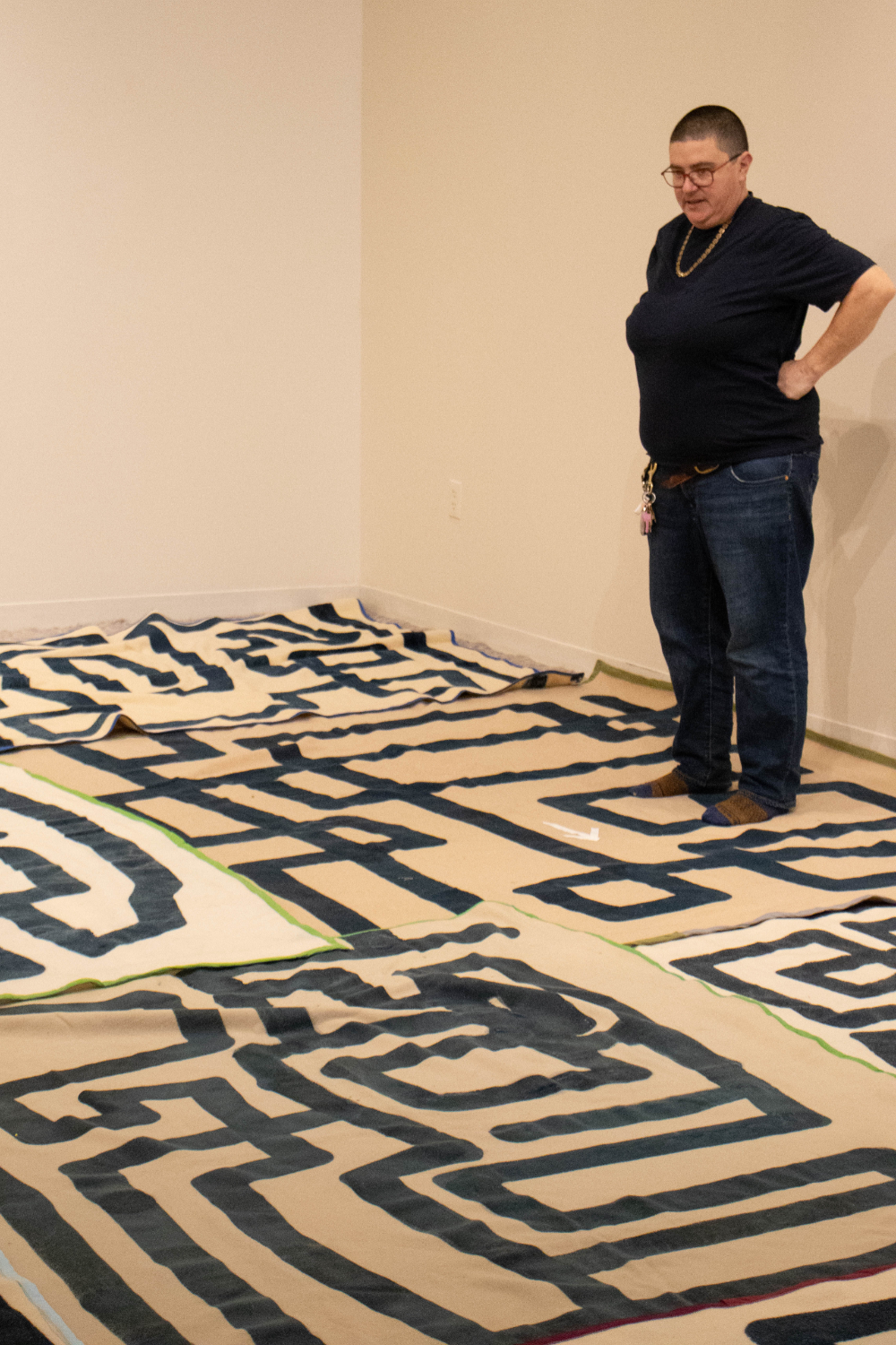 Emmy Bright looks at a carpet maze in an exhibition room