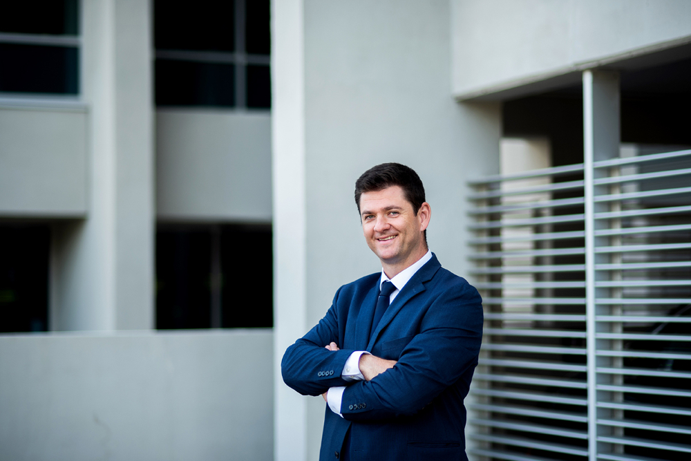portrait of Milos Topic standing outside Zumberge Hall