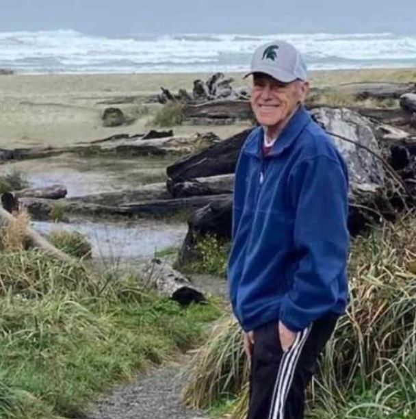 Norman Leeling standing near water, beach