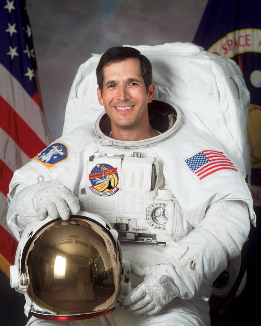 John Herrington in an astronaut uniform with helmet