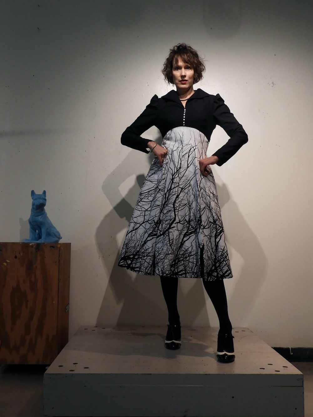 Kirsten Strom in a dress with a skirting that looks like tree branches