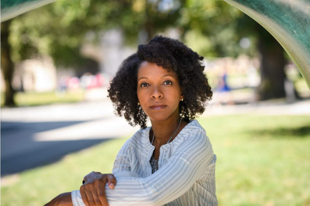 Imani Perry seated outside