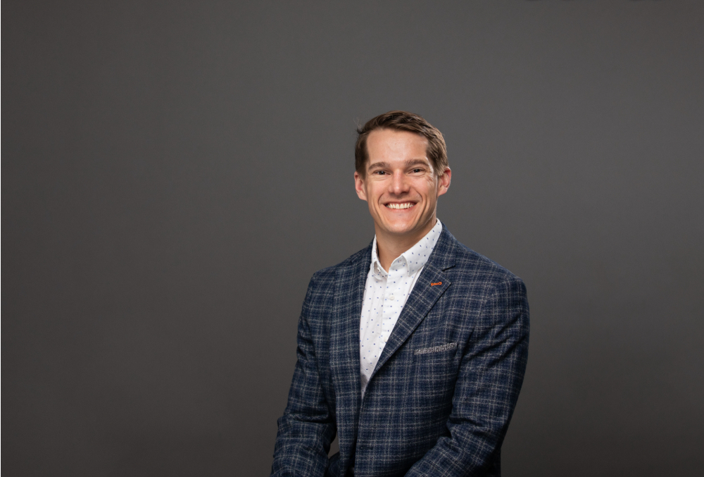 Colin Brander in dark suit jacket and white shirt