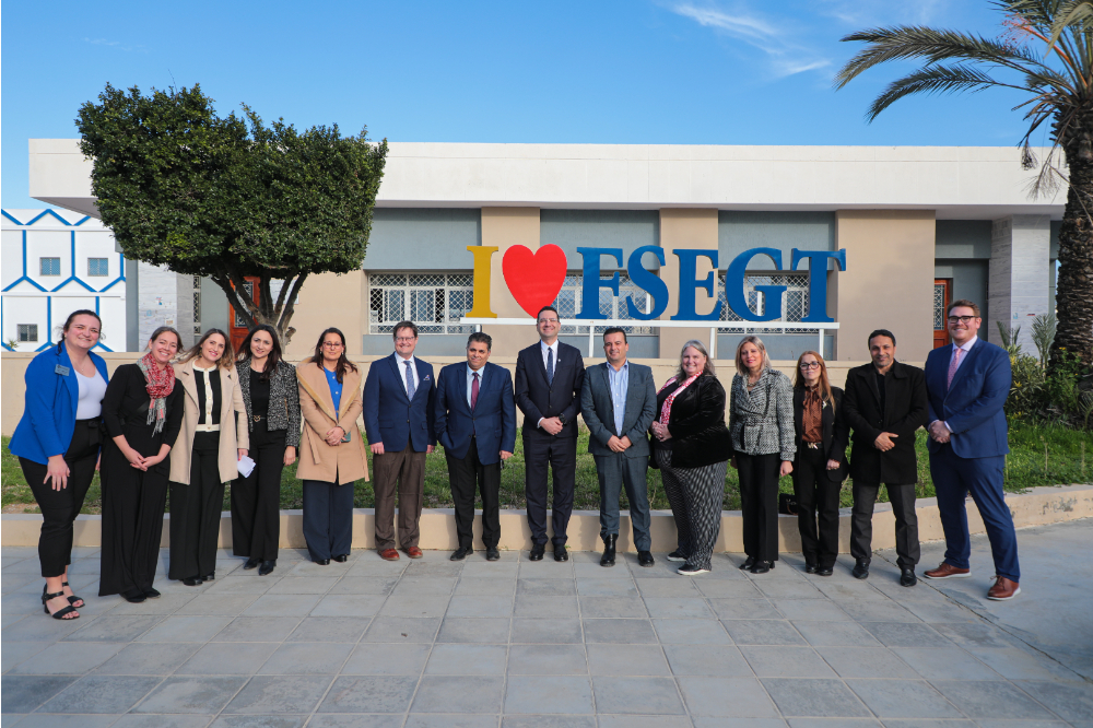 group of people standing in front of a building in Tunisia