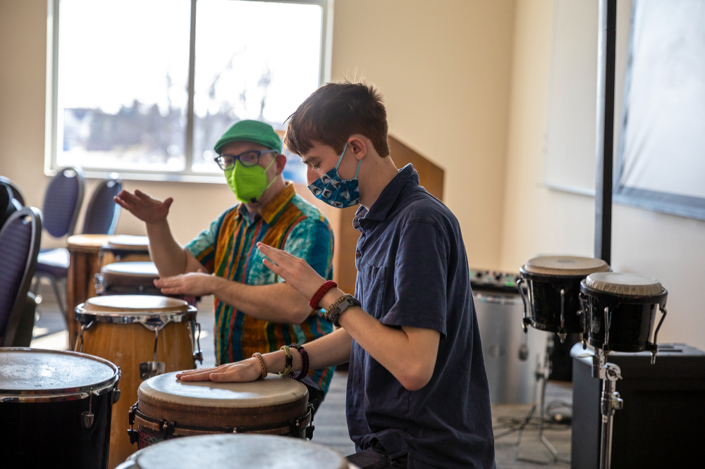 two men drumming with open palms
