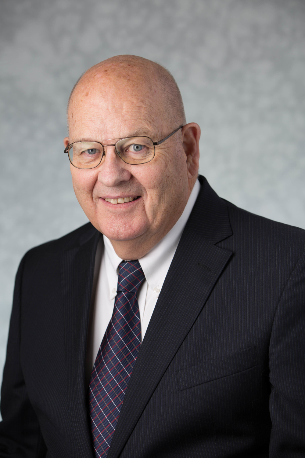 Mel Northup in dark suit jacket and white shirt