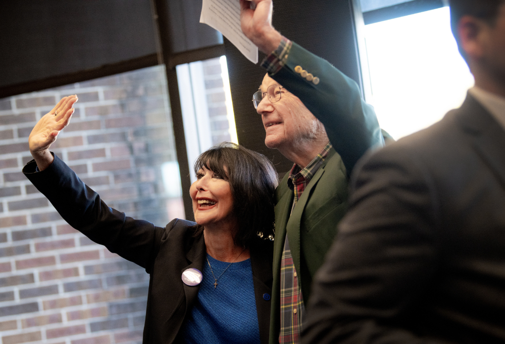President Mantella, left, and Bob Thompson wave during an event in the Kirkhof Center