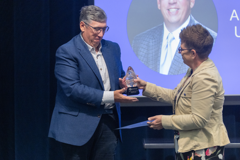 Dan Hurwitz accepts an award from a woman