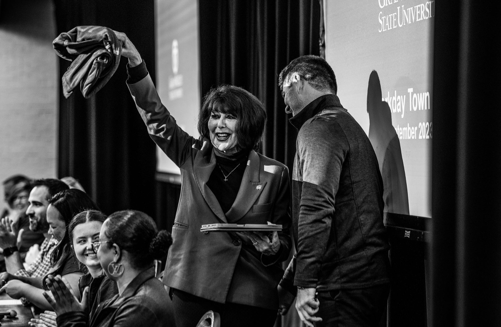 President Mantella happily waves a jacket while leaving the podium