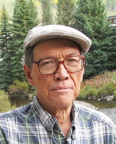 Roelof Bijkerk standing outside by stream in driving cap