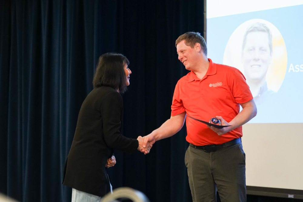 President Mantella, at left, shakes the hand of Chris Babbitt