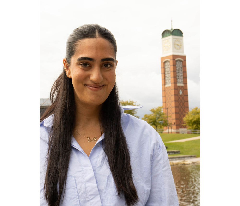 Dana Harb standing outside with clocktower over her left shoulder