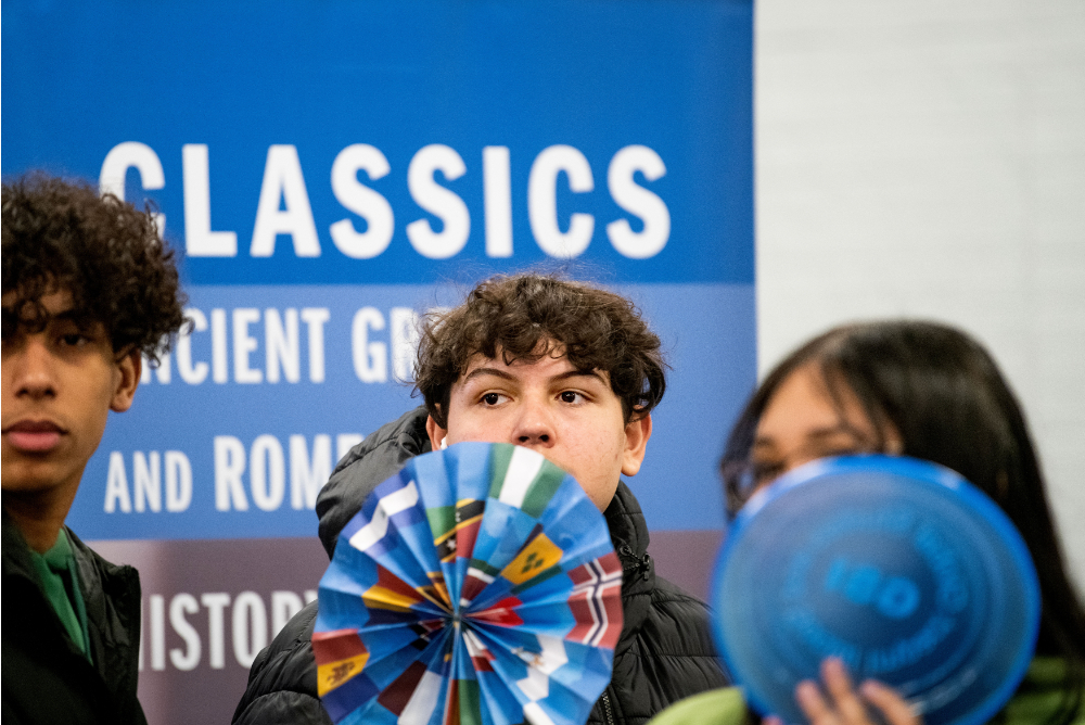 three students in front of banner that reads Classics