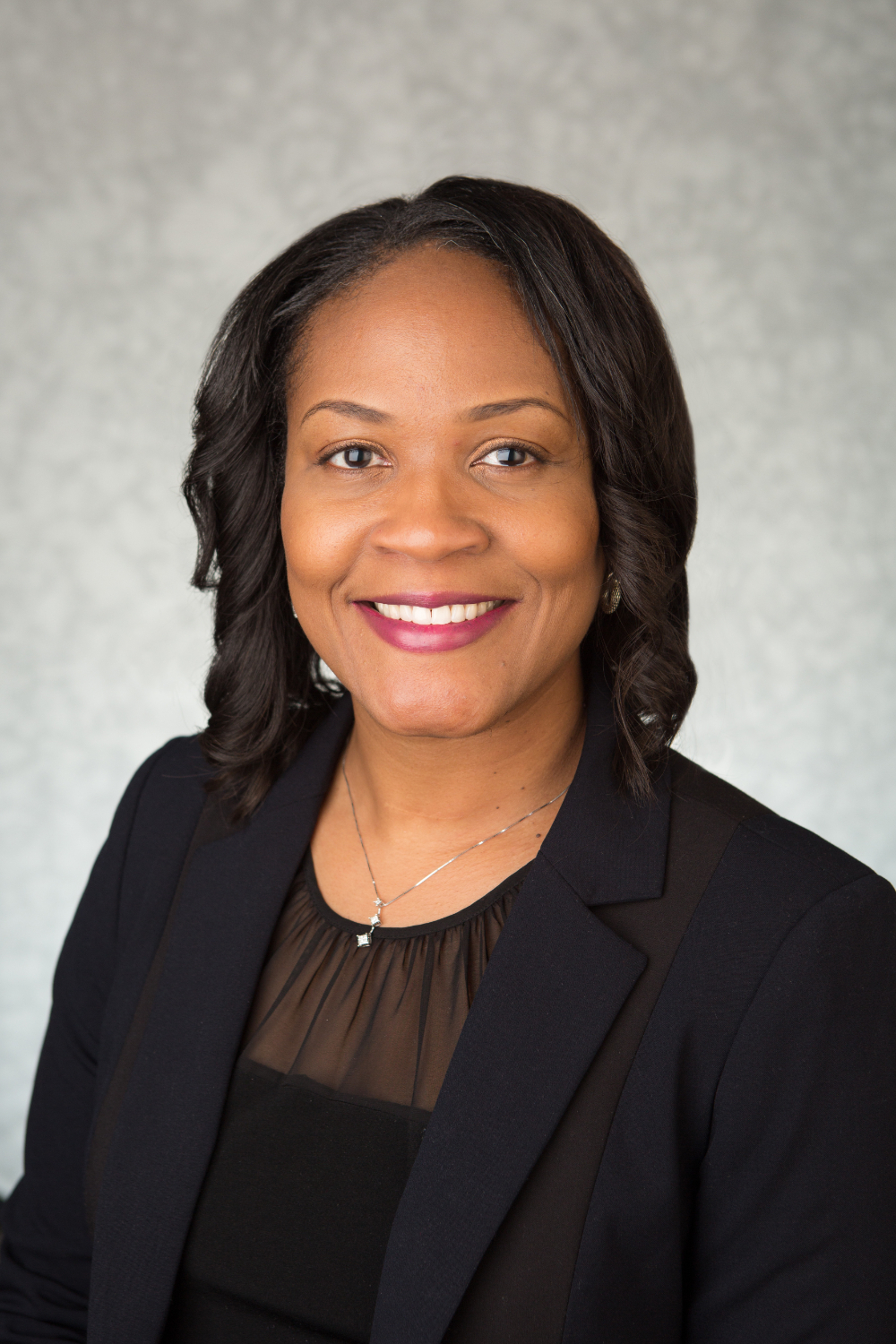 Shontaye Witcher in a black shirt and jacket