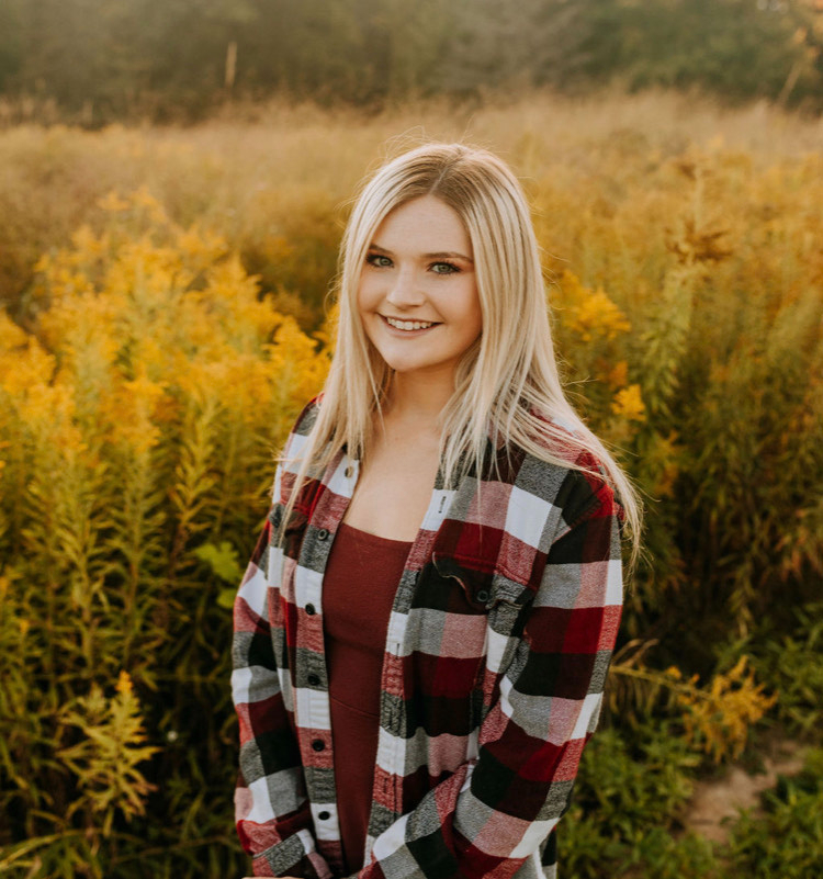 headshot of Kaley Louck, standing in a field