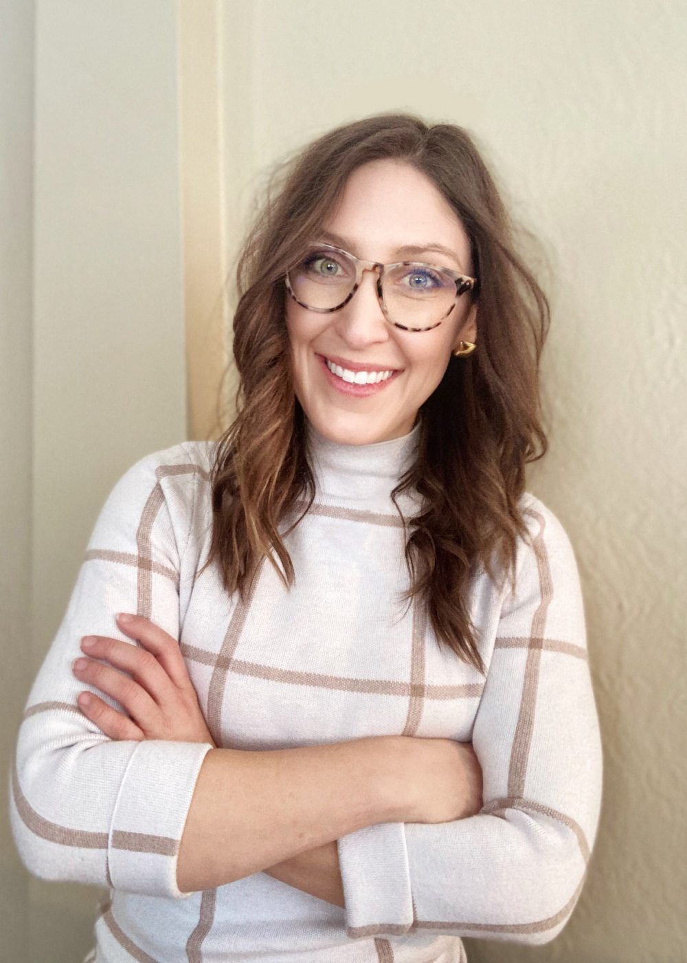headshot of Zoe Fry standing against a beige wall