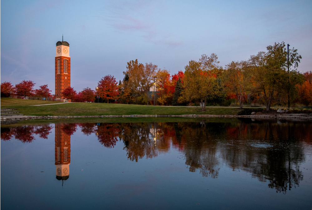 carillon tower reflecting in Zumberge Pond, fall colors on trees