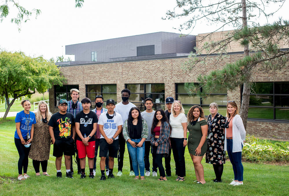 large group of students, faculty stand outside the Kirkhof Center in two rows