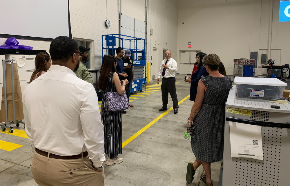 Tim Born, associate dean for the Padnos College of Engineering and Computing, addresses a visiting group of counselors from Pakistan in the Shape Corp. Innovation Design Center.