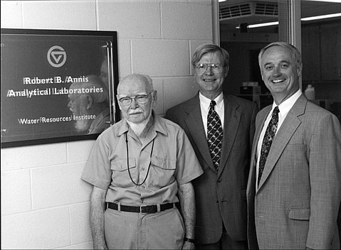 From left are Robert B. Annis, Ron Ward and Douglas Kindschi next to a plaque with GV circle logo, Robert B. Annis Analytical Laboratories, Water Resources Institute