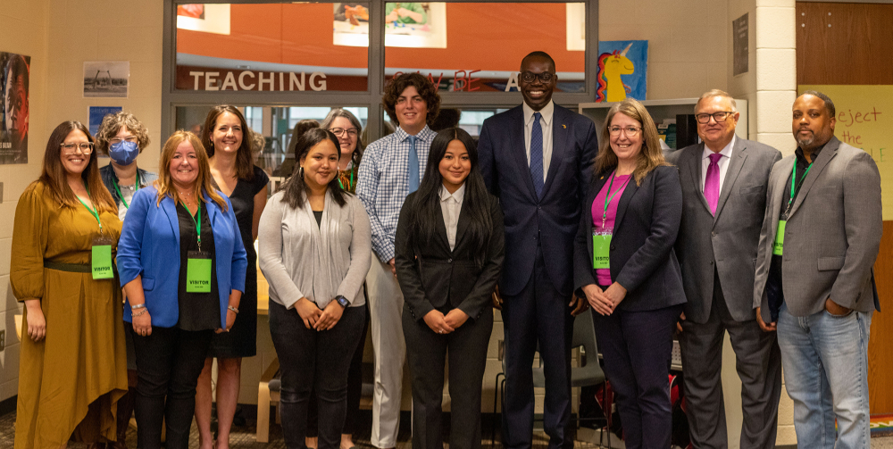large group of 11 people standing in a hallway with Lt. Gov. Garlin Gilchrist