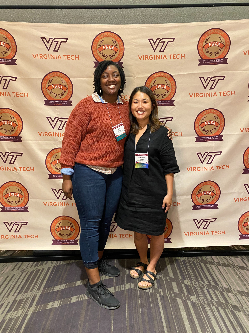 two women against a backdrop of Virginia Tech