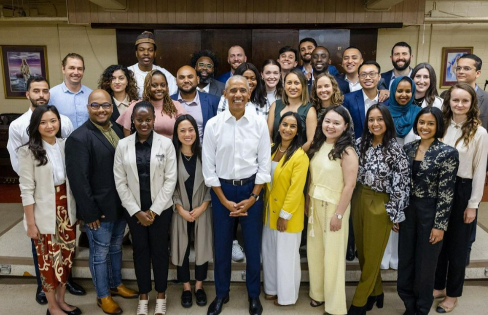 three rows of young professionals stand with President Barack Obama at front center