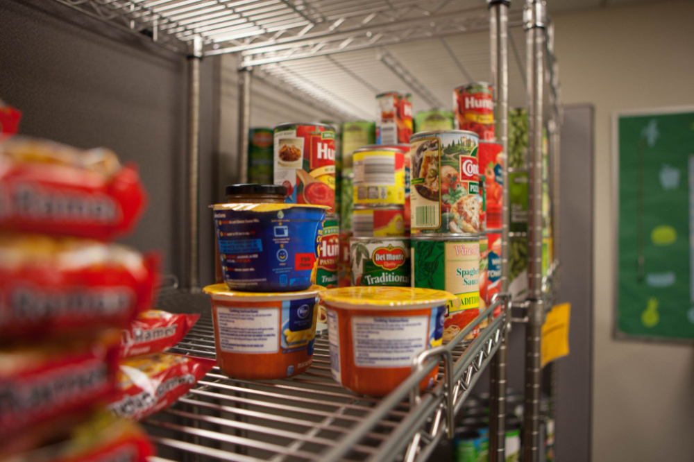 metal shelf at Replenish with ramen packets and canned goods