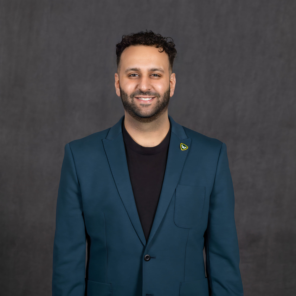 Brandon Shamoun standing in dark shirt and jacket