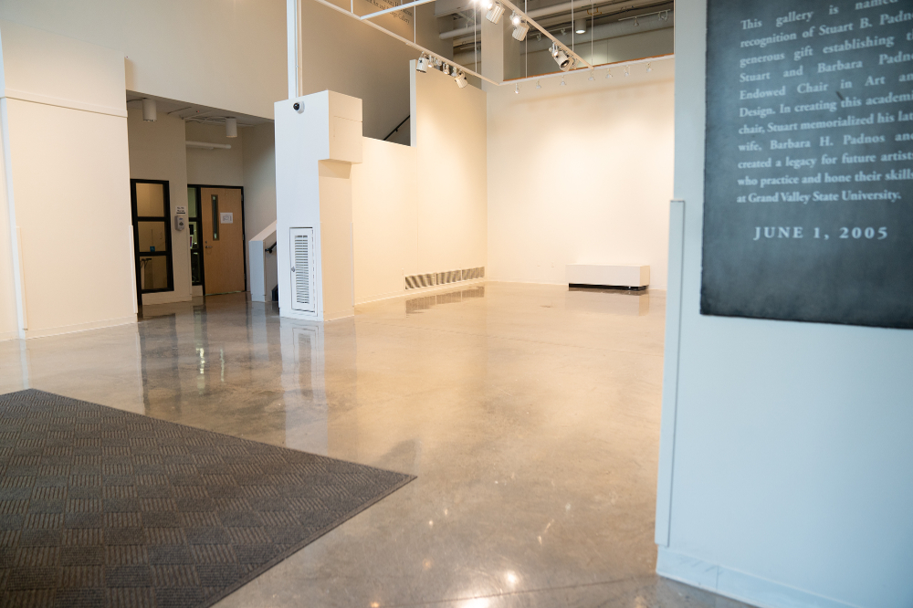 empty gallery space, hallway entrance on left side, sign dedicated to Stuart Padnos on right