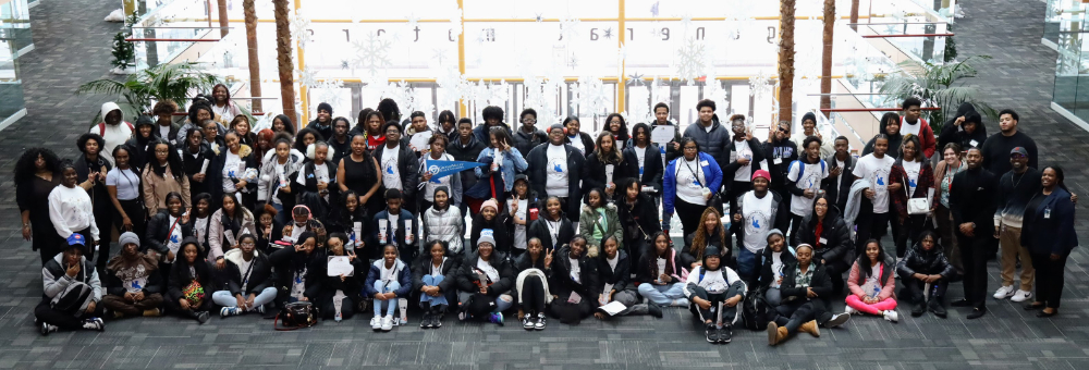 large group of people standing and seated on floor at the Detroit Renaisance Center