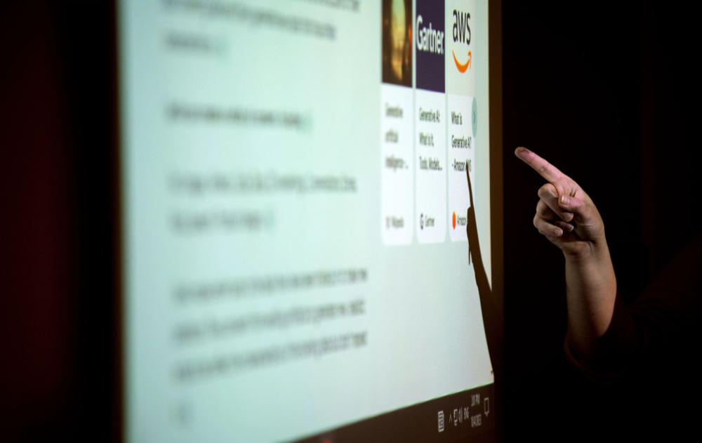 hand pointing at screen that shows AI tools and a description