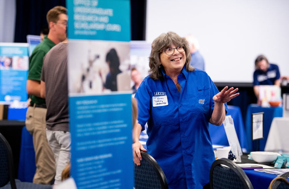 woman standing by a vertical banner