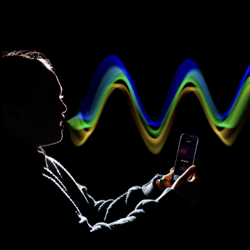 silouette of person with rainbow sound waves coming from her mouth, waves created in photoshop after photo was taken