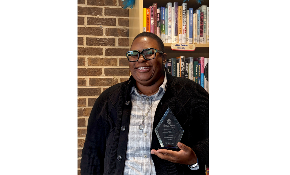 DL McKinney holds a glass award