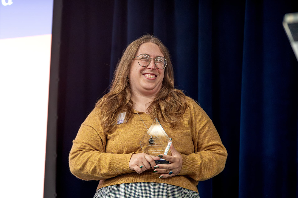 Hannah Scholten holds the Jennifer Palm Community Impact Award