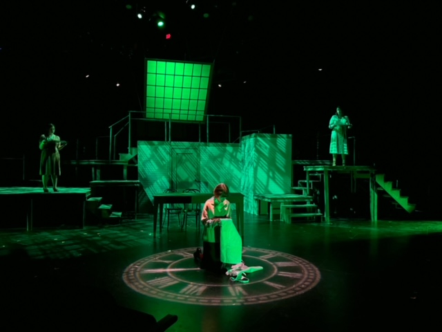 with green tones, a theater scene of three actors