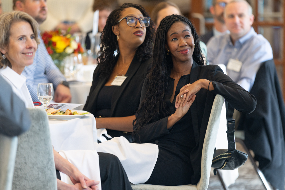 at right, Justice Kyra Harris Bolden turns in her chair, others seated at round tables