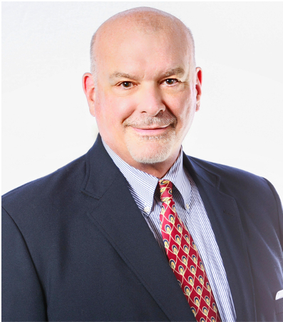 Brooks Kindel in dark suit jacket and light blue shirt