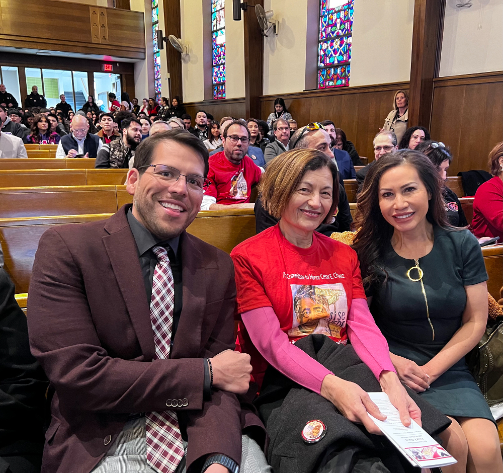 three people seated inside a church